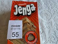 Front of box showing Classic Jenga game with tower and wooden blocks visible through window.
