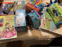 Various odd and end items including Fancy Nancy Puzzle, Grow Pot Kit, Bubble Fish Set, small tin suitcase and assorted toys.