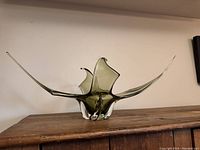 Front angle view of the large mid-century blown glass centerpiece on wooden surface, showing full length and sculptural shape with pointed ends.