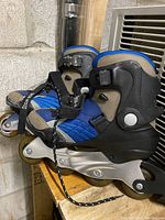 Side view of Sherwood Arch Lite rollerblade on wooden surface with visible details of wheels, frame, and boot materials.