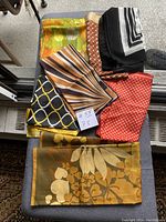 Overview of all 7 vintage scarves arranged showing various patterns and colors