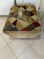 Top view photo showing the patchwork fabric upholstery with geometric shapes in muted earthy colors