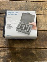 Boxed Impact Flip Socket Set placed on wooden surface showing label with contents and features