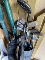 Showcases the full set of ladies golf clubs in bag, displaying irons and woods with some wear and tear.