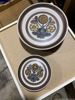 Two Langley dinner plates stacked showing the floral design and brown rim.