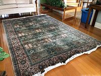 Full view of Persian rug laid out on hardwood floor in living room