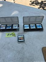 13 Nintendo game cartridges, 12 Nintendo DS games in two open plastic cases and one separate Nintendo 3DS game cartridge.