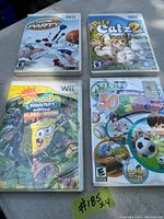 Photo of four Nintendo Wii game cases arranged in a grid on a surface. Covers of Game Party, Petz Catz 2, SpongeBob SquarePants: Motion Toss and Gloss Doom, and Family 30 Great Games are visible, showing their artwork and titles.
