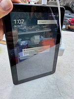 Tablet screen showing home interface with search bar and dictionary update notification, displaying time and date.