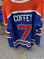 Back view of the blue Edmonton Oilers sweater showing Paul Coffey name and number 7 with signature on the 7.