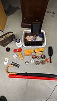 Wide view of the shoe care lot contents showing brushes, polish tins, shoehorn, cleaning sponge, umbrella and bag.