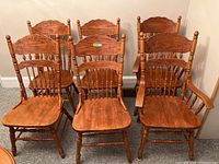 Full set of six carved wooden chairs arranged in two rows, showing two armchairs and four armless chairs.