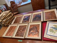 Seven framed embossed copper art pieces with subjects including horses, ballerina, flowers.