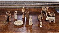 Photo showing entire nativity set including Mary, Joseph, wise men, animals, and manger all hand carved from wood.