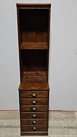 Full view of the tall wooden hutch with shelves and file cabinet below, showing the entire piece and hardware.
