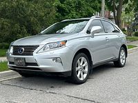 Front three-quarter driver side view showing grille, headlights, alloy wheels and front fascia