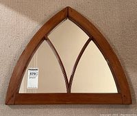 Front view of entire arched mirror laid on carpet