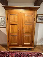 Full front view of the pine cabinet showing doors and crown molding