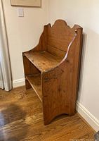 Angled side view showing curved side panel and shelf edges