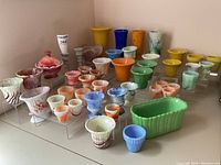 Overall arrangement of approximately 35 Akro Agate slag glass pieces on clear risers