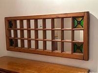 Full front view of rectangular mirror showing wood grid and stained glass corner panels.