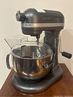 Front-left view of mixer assembled with bowl, whisk and pouring shield
