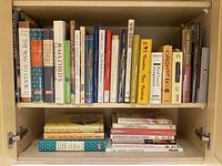 Overall view of two shelves filled with assorted cookbooks