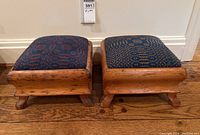 Two pine footstools side by side against wall