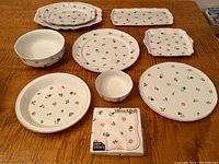 All ceramic pieces and napkin pack arranged on table