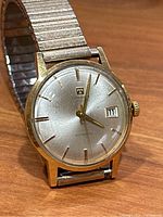 Front view showing dial, applied indices, hands and date window