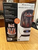 Photo of Baby Brezza sterilizer dryer box front showing product image, features, and branding.