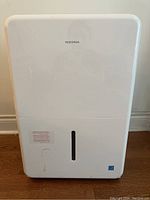 Front view showing Insignia logo, removable water tank with level indicator