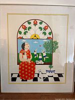 Front view of framed print depicting woman, cats, and children playing ball