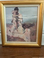 Framed original artwork showing woman holding child seated outdoors in muted tones