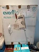 Box of Evenflo Versatile Play Space, showing brand and usage details.