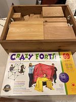 Wooden blocks in wooden box with Crazy Forts box visible
