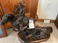 Front view of bronze sculpture on wood base