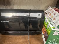 FoodSaver V3425 vacuum sealer front view showing control buttons and power cord.