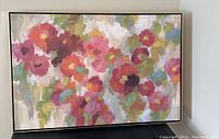 Full view of floral acrylic painting on canvas, showing colorful abstract flowers in a metal frame.