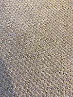 Close-up of beige sisal textured weave showing the natural fibers and textile pattern.