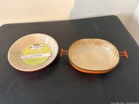 Deep dish round pie pan and oval baking dish side by side showing size and condition