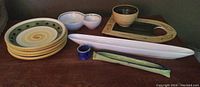 Lot of olive-themed ceramic serveware including plates, olive boats, bowl, cup, and tray with matching bowl.