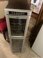 Front view of Koolatron dual compartment wine cooler with digital panel and glass doors showing interior racks.