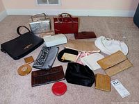 Overview of all items laid out including various handbags, wallets, clutches, and purses