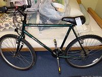 Full side view of the men's mountain bike showing frame, tires, handlebars, seat, and pedals.