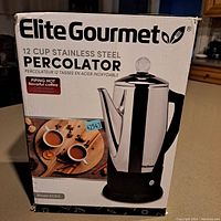 Front view of the box showing Elite Gourmet 12 cup stainless steel percolator model EC812 image and branding.