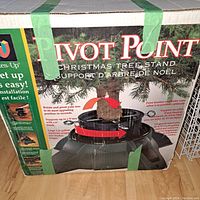 Original boxed packaging of Pivot Point Christmas Tree Stand showing product image and branding.