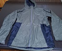 Top view of Columbia men's small jacket laid flat showing front details and color contrast