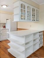 Photo of a white kitchen island with a Corian countertop for context reference.