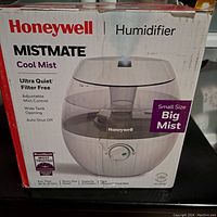 Front side of the Honeywell Mistmate Cool Mist Humidifier box showing product image and key features like ultra quiet operation, filter free, adjustable mist control, wide tank opening, and auto shut off.